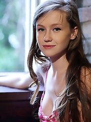 "Cute and sweet Emily Blooms slowly undress her pink floral dress, revealing her smooth, nubile body."